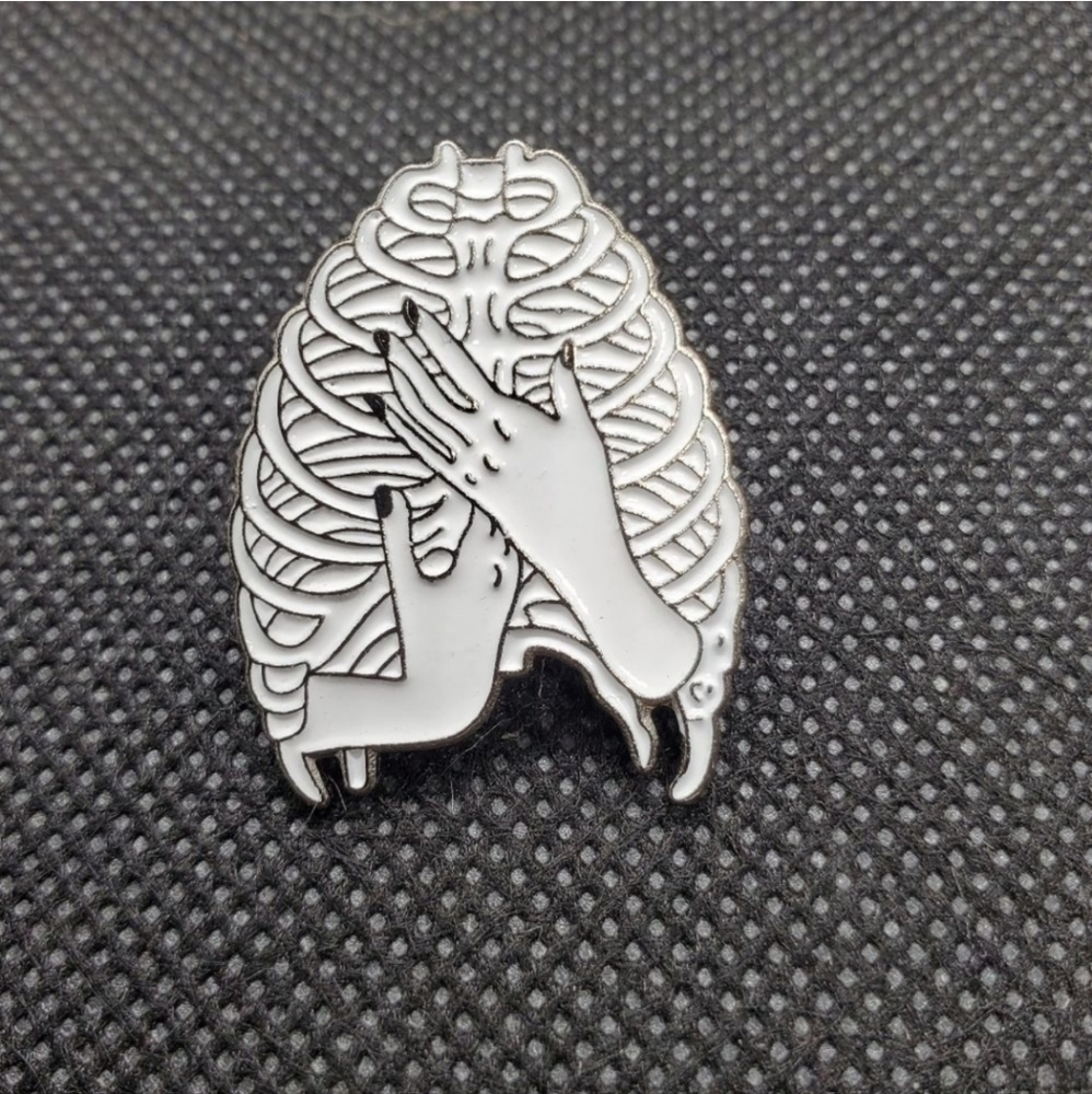 Hands and rib cage enamel pin. Beautiful and elegant hands and rib cage